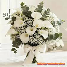 A soft bridal bouquet of white calla lilies, baby's breath and eucalyptus tied with cream ribbon